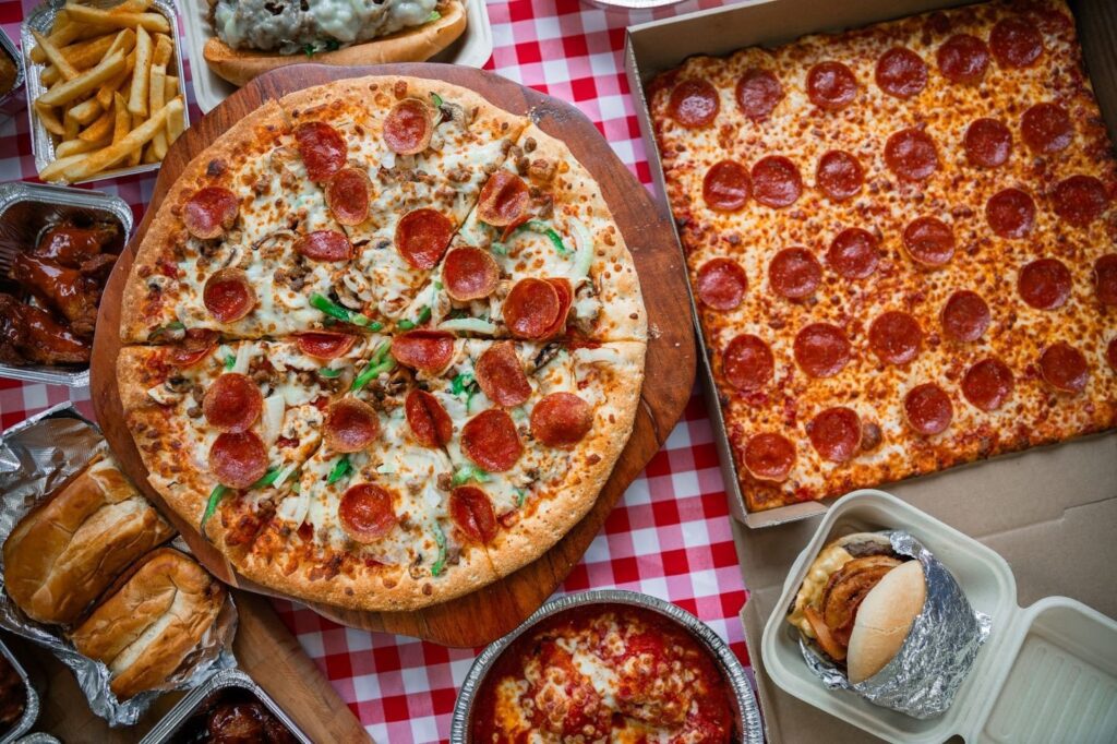 A delicious party menu featuring pizzas, burgers, wings, fries, and pasta.