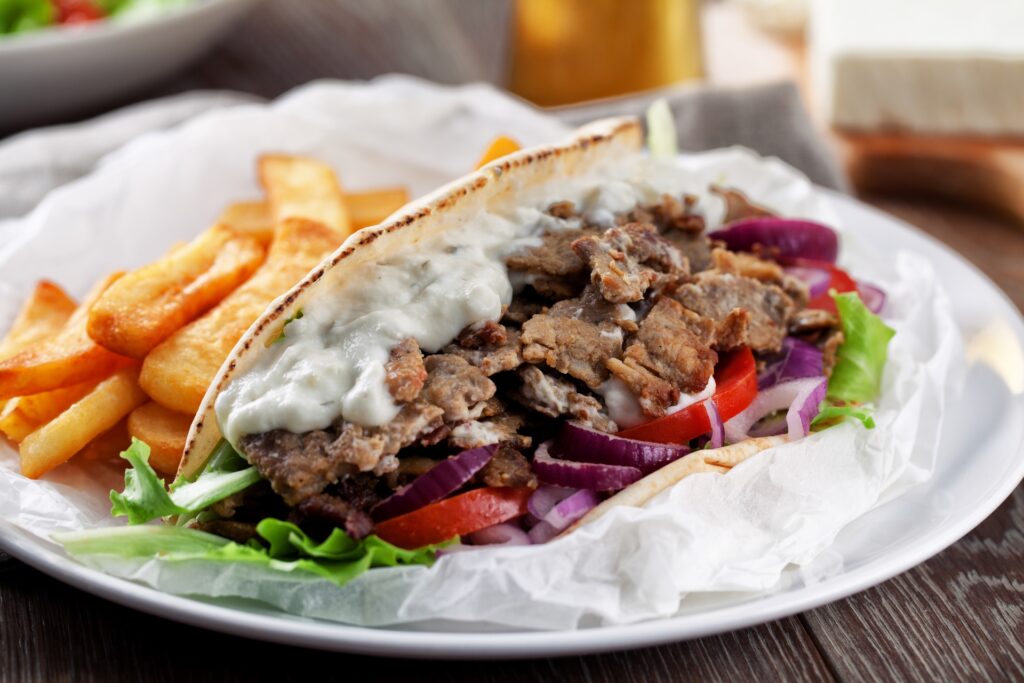 Chicken gyro wrapped in pita with golden fries and fresh salad at Manny & Olga’s in Washington, DC.