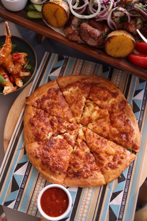 A flat-lay image of pizza with a variety of dipping sauces, offering diverse flavor options for every bite.