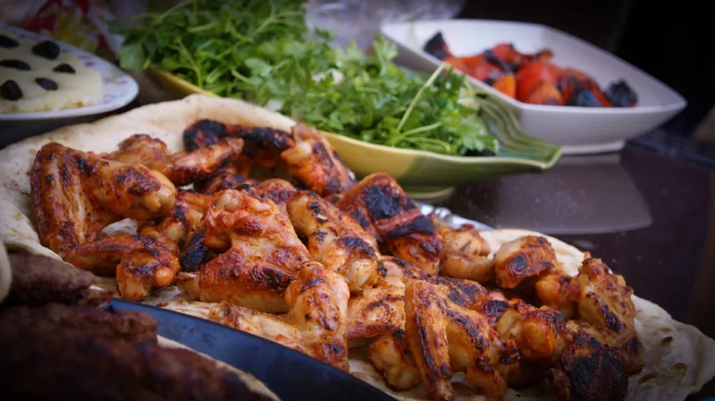 Hot spicy buffalo wings served on a platter.
